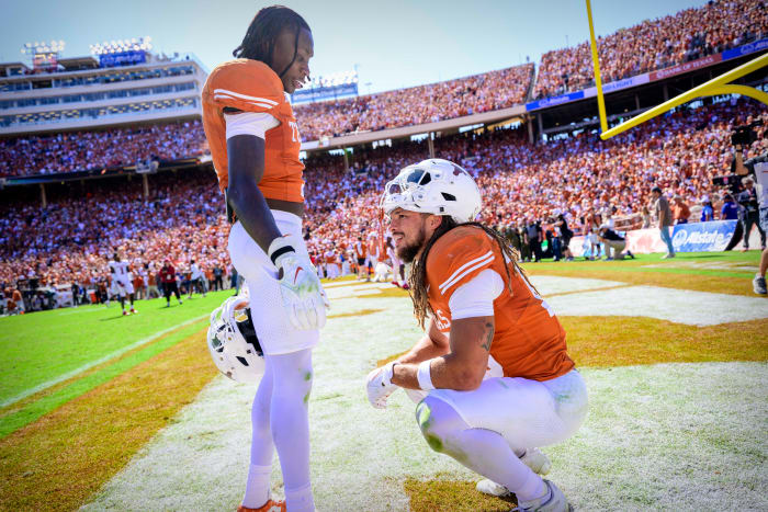 Texas Longhorns wide receiver Xavier Worthy (1) checks on wide receiver Jordan Whittington (13) after the Longhorns lose to the Oklahoma Sooners at the Cotton Bowl.